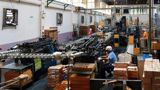 An appliance production line running assembled units between stations.