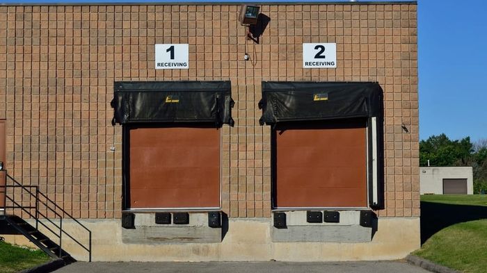 Receiving docks on a distribution building, dock doors and levellers in a row.