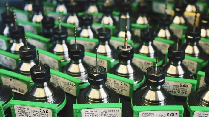 Machine toolholders racked and labelled in a production shop.